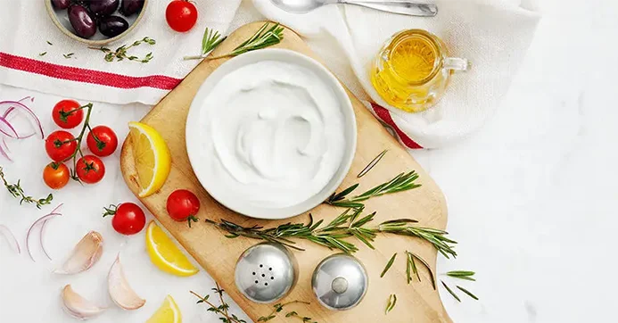 Cutting board with honey, yogurt fruits and vegetables
